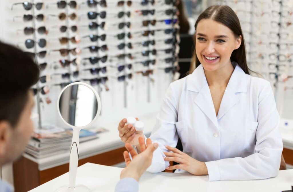 An eye doctor explains their adult patient's new contact lens prescription to them and how it differs from their eyeglasses.