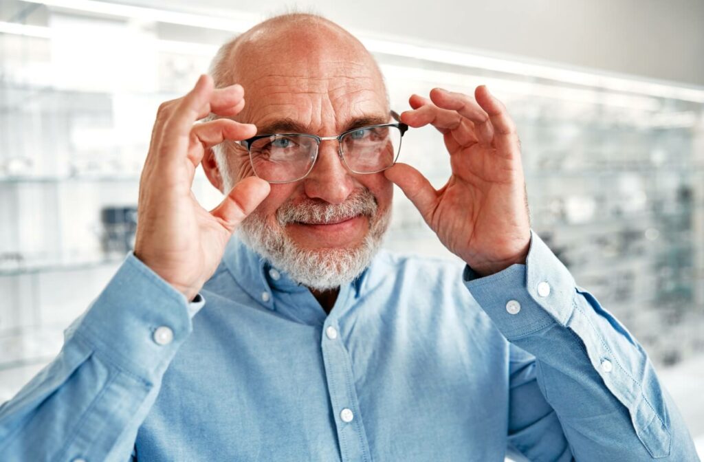 A mature patient fixes their eyeglasses, which corrects their refractive error, allowing them to enjoy clear vision.