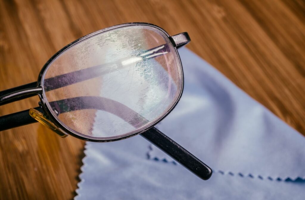 An eyeglass lens with light scratches and smudges.