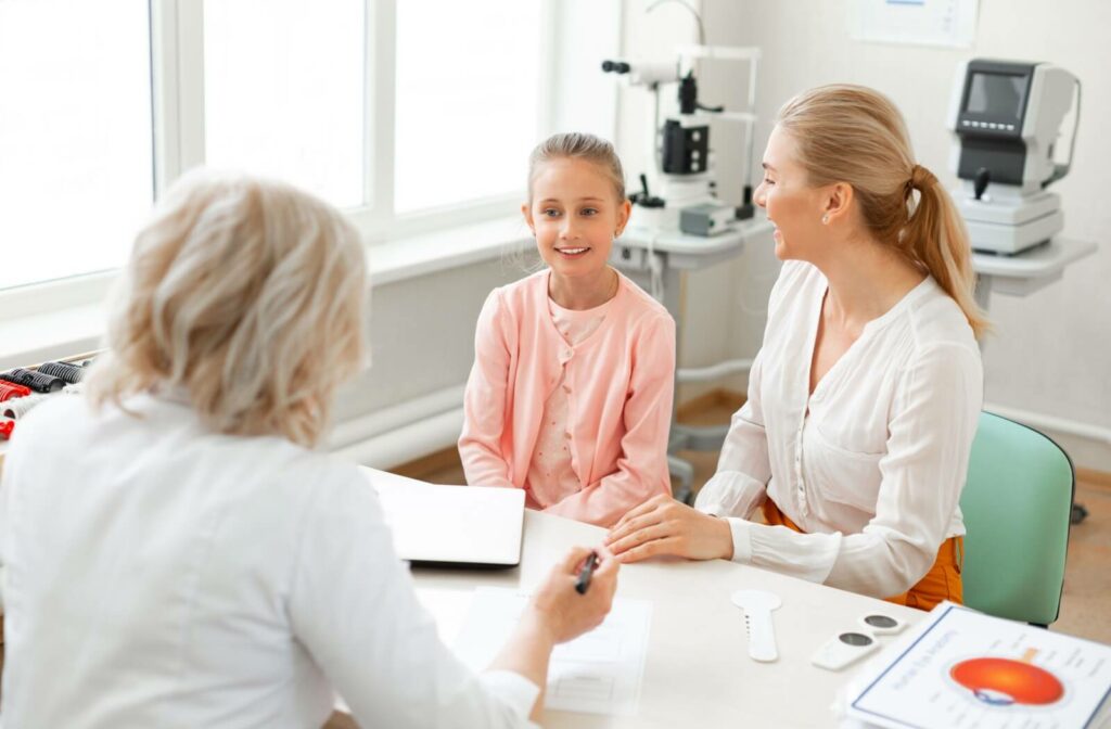An optometrist explains the importance of myopia control therapies to a young patient and their parent.